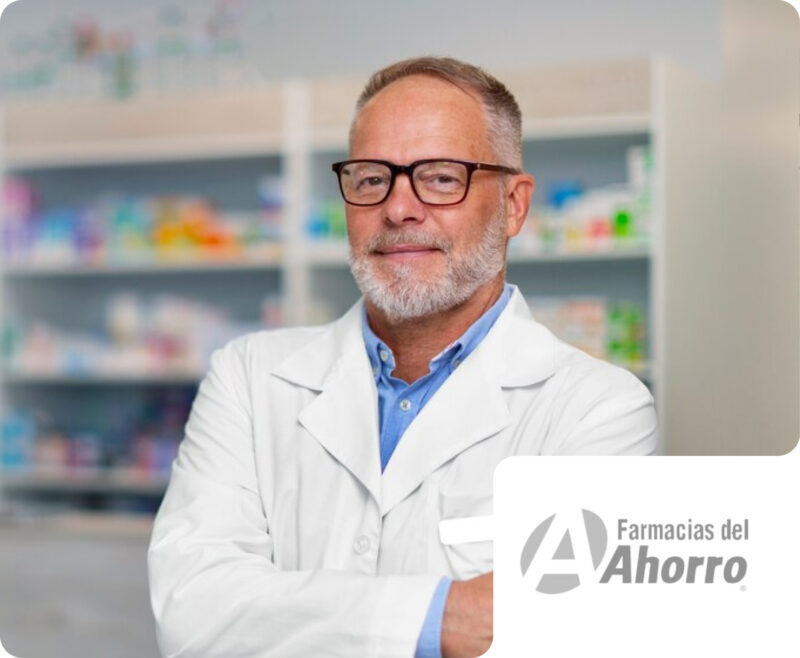A professional pharmacist in a white coat and glasses standing confidently with crossed arms in front of pharmacy shelves, with a Farmacias del Ahorro brand badge. This highlights Flipflow's solutions for monitoring retail execution, pricing, and assortment in the pharmaceutical and healthcare retail market.