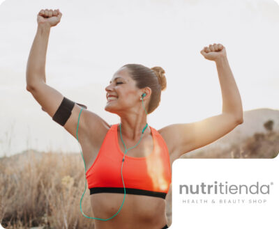 A fit woman in an orange sports bra celebrating with raised fists after an outdoor workout at sunset, with a nutritienda HEALTH & BEAUTY SHOP brand badge. This represents Flipflow's solutions for e-commerce intelligence and price monitoring for online health and beauty retailers.