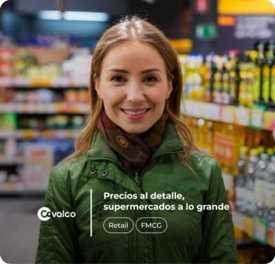 Alt text: "A smiling woman in a green jacket and patterned scarf standing in a supermarket aisle. Shelves stocked with various products, such as bottles and boxes, are blurred in the background. The text overlay includes 'Covalco' with a logo, 'Precios al detalle, supermercados a lo grande,' and buttons labeled 'Retail' and 'FMCG.'"